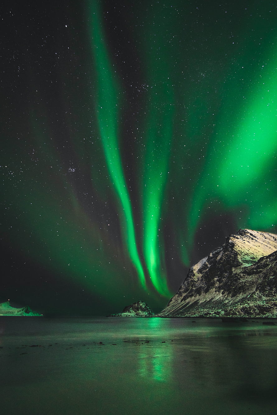 Vibrant Green Aurora Borealis Dancing Over Snow-Capped Norwegian Mountains and Fjord HD phone wallpaper
