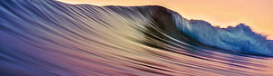 Dramatic Ocean Wave Curling at Sunset with Warm Golden Sky and Blue Foam HD wallpaper
