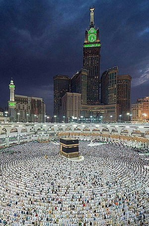 Kaaba and Makkah Clock Tower at Night with Pilgrims in Tawaf Circles HD phone wallpaper