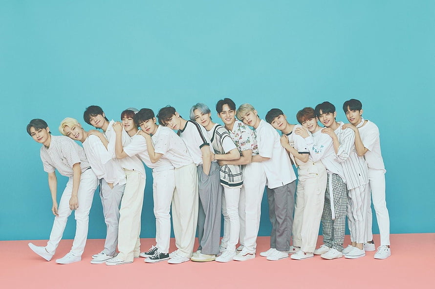 SEVENTEEN K-pop Group Members in White Casual Outfits Against Teal and Pink Studio Background HD wallpaper