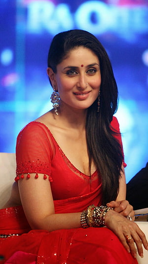 Kareena Kapoor in a vibrant red sari with ornate jewelry and elegant updo HD phone wallpaper