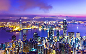 Hong Kong Victoria Harbour Skyline at Dusk with Vibrant City Lights and Purple Twilight Sky HD wallpaper