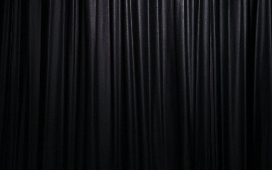 Elegant Black Velvet Curtain Fabric with Deep Vertical Folds and Soft Sheen HD wallpaper