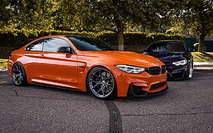Orange BMW M3 F80 Coupe with Custom Widebody and Dark Purple BMW M3 Parked on Street HD wallpaper