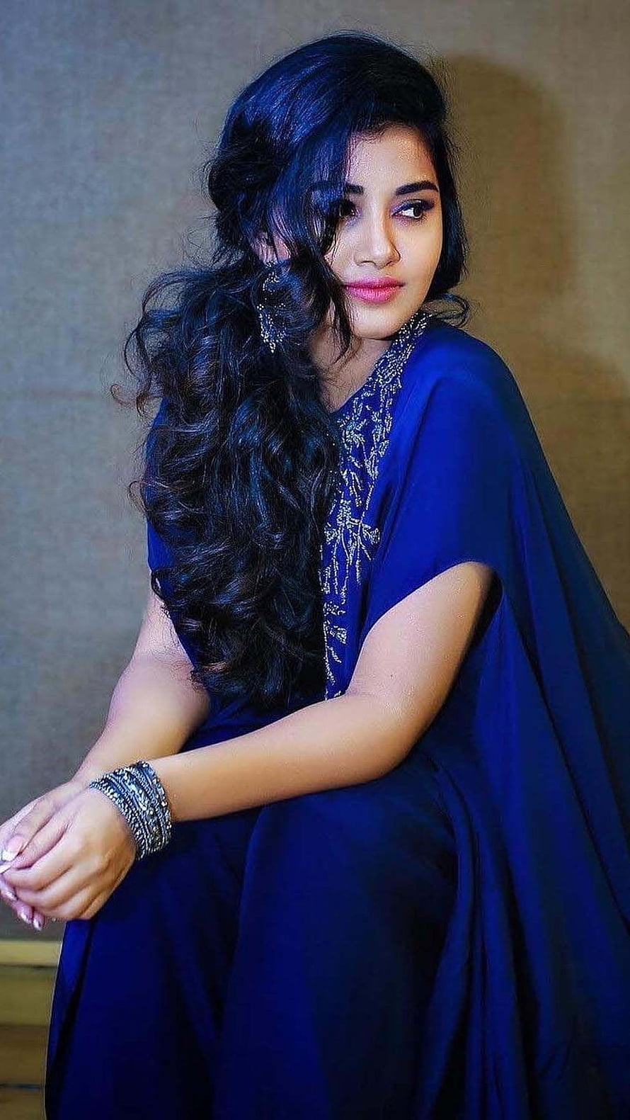 Anupama Parameswaran in a royal blue embroidered dress with long wavy hair and silver jewelry HD phone wallpaper