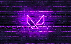 Glowing purple Valorant emblem mounted on a dark brick wall with neon lighting HD wallpaper