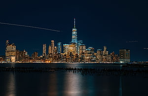 New York City Lower Manhattan Skyline at Night with One World Trade Center and Hudson River Reflections HD wallpaper