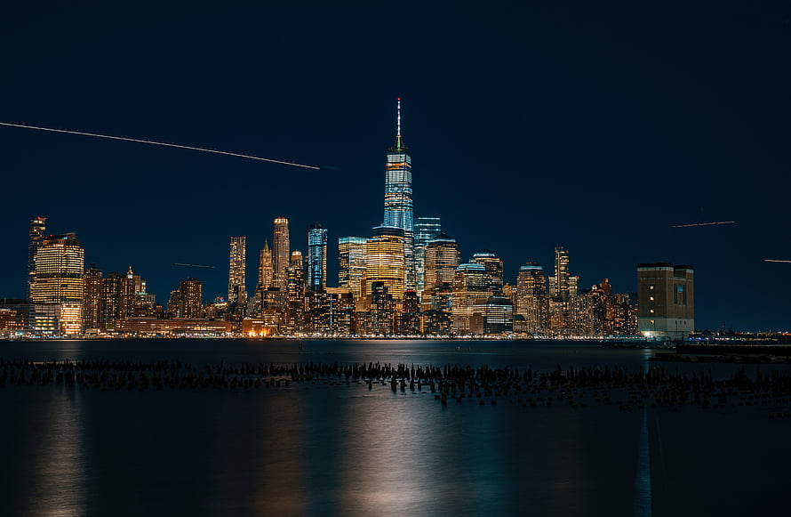 New York City Lower Manhattan Skyline at Night with One World Trade Center and Hudson River Reflections HD wallpaper