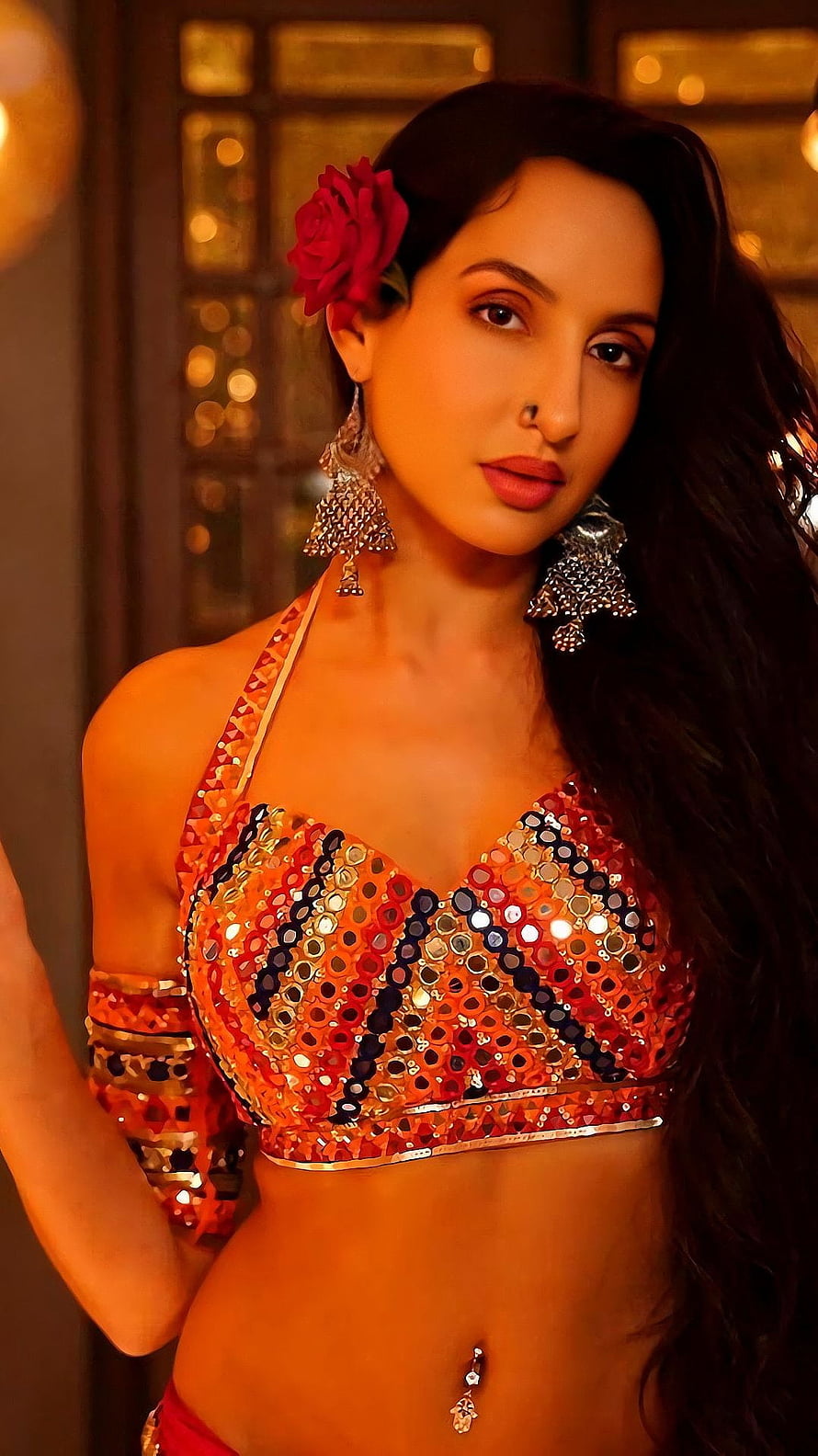 Nora Fatehi in a Sequined Orange Halter Top with Floral Hairpiece and Traditional Jewelry HD phone wallpaper