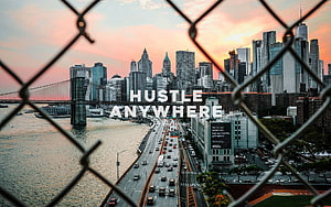 New York City Skyline at Sunset Viewed Through Chain Link Fence HD wallpaper
