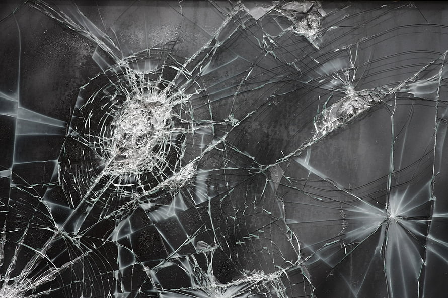 Shattered Glass Texture with Radiating Fracture Lines and Impact Points HD wallpaper