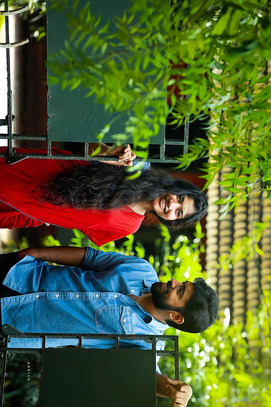 Premam Movie Still Featuring Sai Pallavi and Nivin Pauly in a Lush Garden Setting HD phone wallpaper