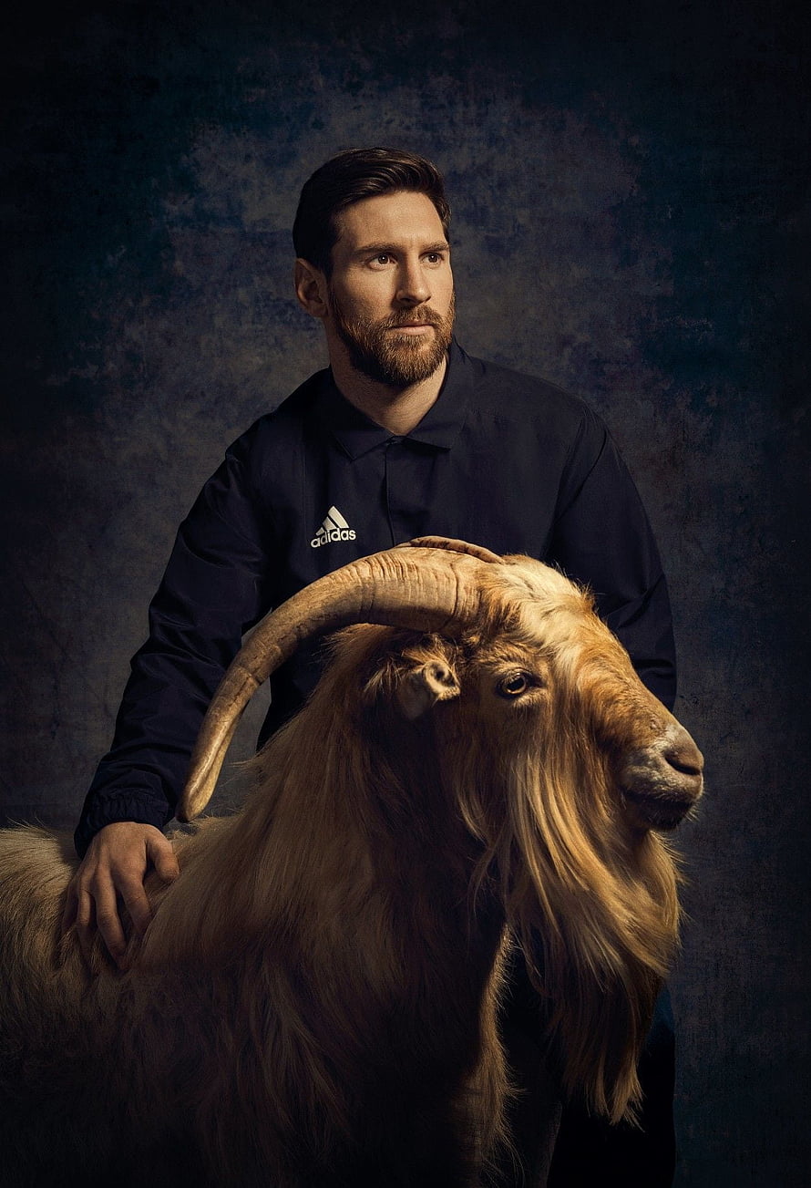 Lionel Messi Portrait with Long-Horned Goat in Dark Studio Setting HD phone wallpaper