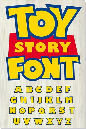 Toy Story Font Alphabet Display with Bold Yellow and Blue Lettering on Wood Background HD phone wallpaper