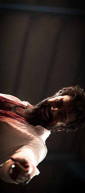 Surya in Vikram: Intense Action Scene with Dramatic Lighting and Blood-Stained Face HD phone wallpaper