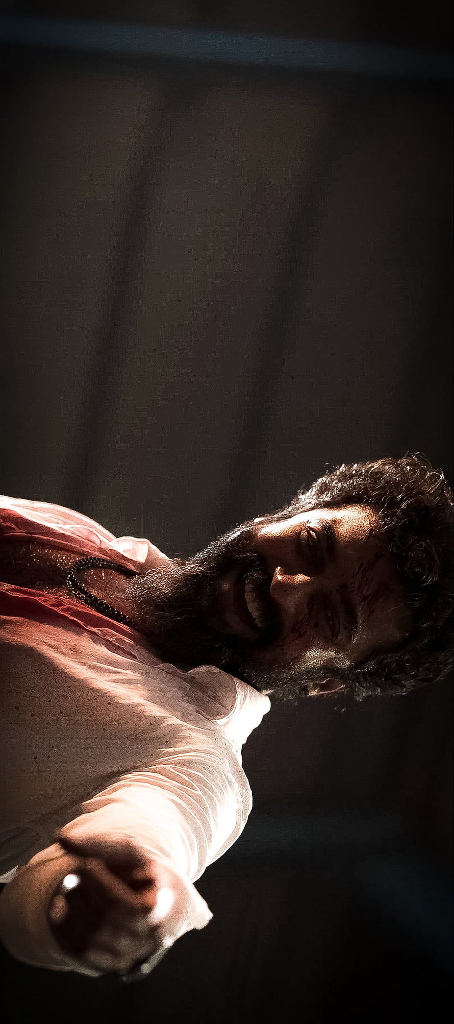 Surya in Vikram: Intense Action Scene with Dramatic Lighting and Blood-Stained Face HD phone wallpaper