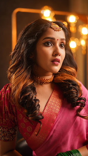 Anikha Surendran in Traditional Pink Saree with Gold Jewelry and Warm Studio Lighting HD phone wallpaper