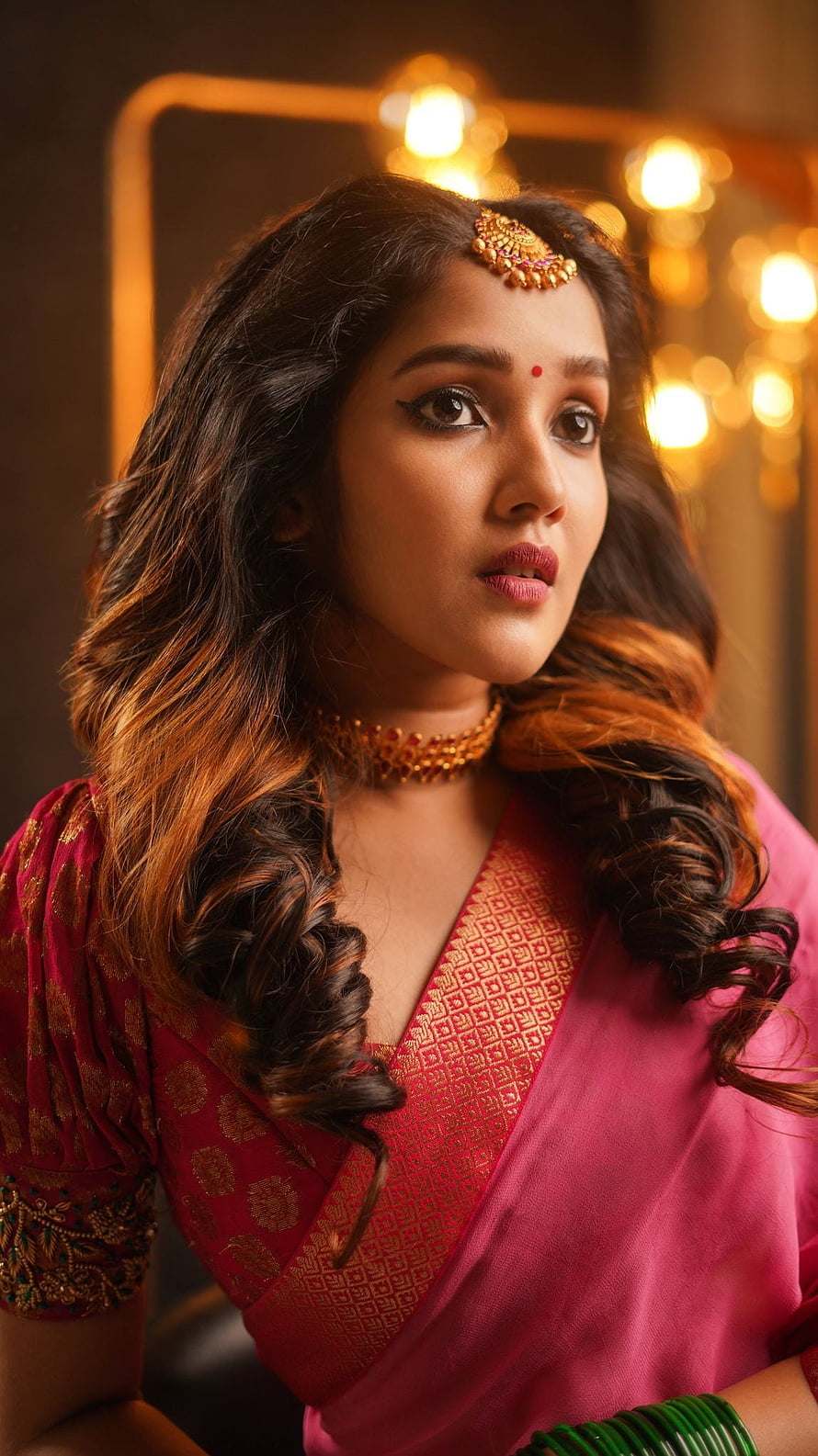 Anikha Surendran in Traditional Pink Saree with Gold Jewelry and Warm Studio Lighting HD phone wallpaper
