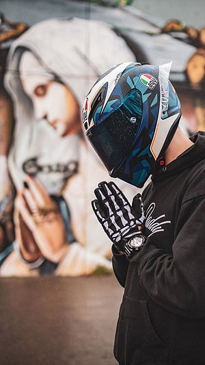 Motorcyclist in AGV Helmet with Skeleton Gloves Before Street Art Mural HD phone wallpaper