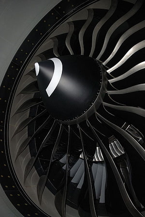 GE90 Turbofan Engine Close-Up: Black Fan Blades and Polished Spine in Monochrome Detail HD phone wallpaper