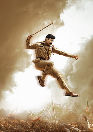 RRR Movie Poster Featuring Ram Charan in Action Pose with Lathi and Crowd HD phone wallpaper