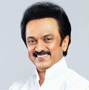 M K Stalin smiling portrait in a white shirt against a light grey studio background HD phone wallpaper
