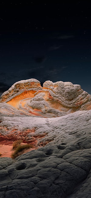 Dramatic Sandstone Rock Formation Under a Starry Night Sky HD phone wallpaper