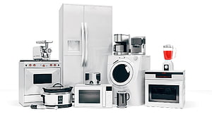 Modern Stainless Steel Kitchen Appliances Collection Including Refrigerator, Oven, and Washing Machine HD wallpaper