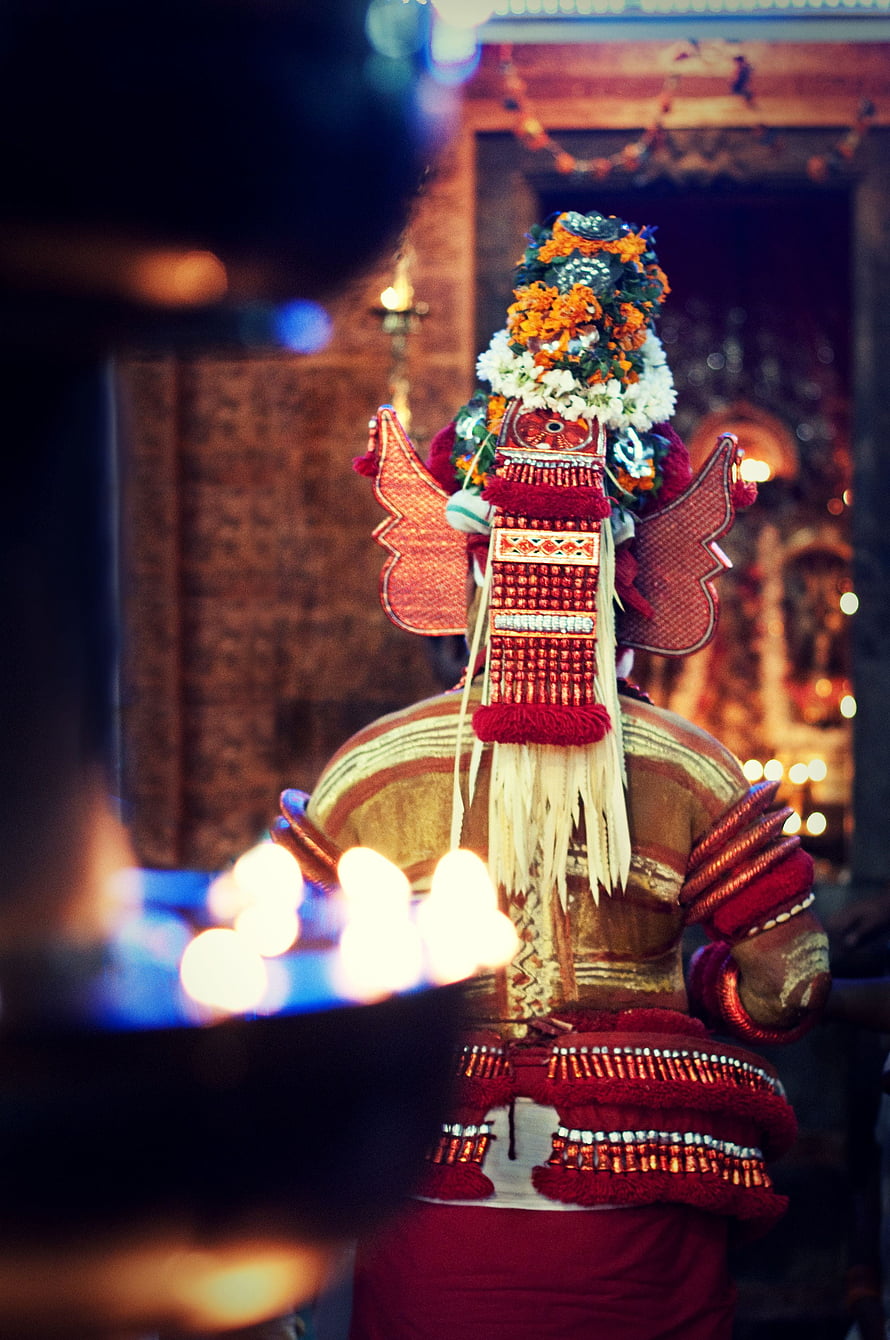 Muthappan Theyyam Ritual Performance in Kerala with Elaborate Floral Headdress and Traditional Attire HD phone wallpaper