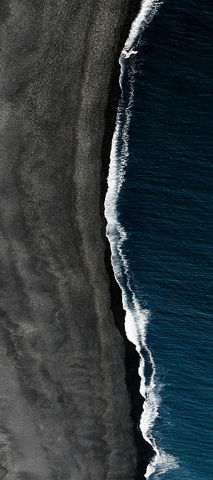Aerial View of Iceland's Black Sand Beach and Deep Blue Ocean Waves HD phone wallpaper