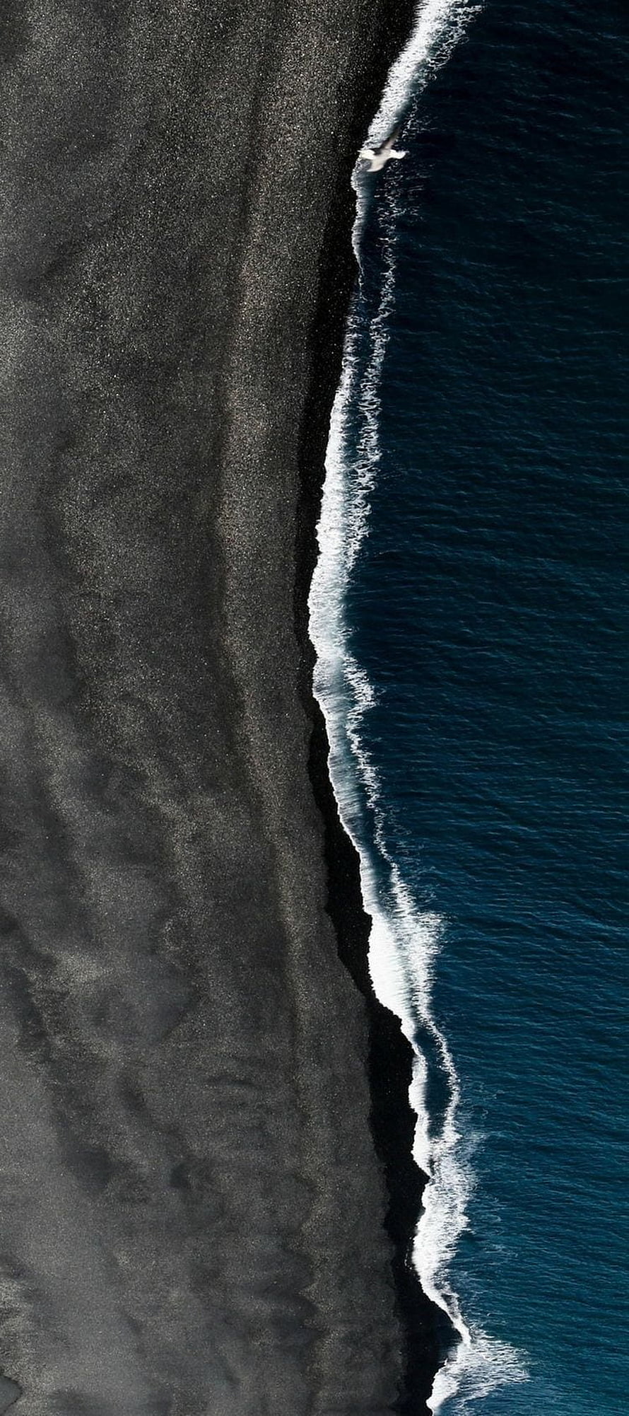 Aerial View of Iceland's Black Sand Beach and Deep Blue Ocean Waves HD phone wallpaper