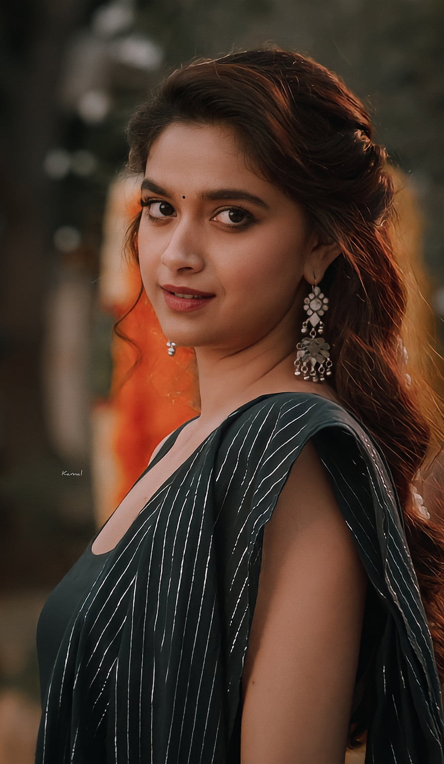Keerthy Suresh in a dark striped sari with traditional silver jhumka earrings and soft natural lighting HD phone wallpaper