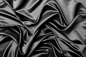 Elegant Black Silk Fabric with Flowing Folds and Lustrous Texture HD wallpaper