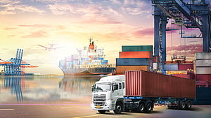 Global Logistics Scene Featuring Cargo Ship, Container Truck, and Port Cranes at Sunset HD wallpaper