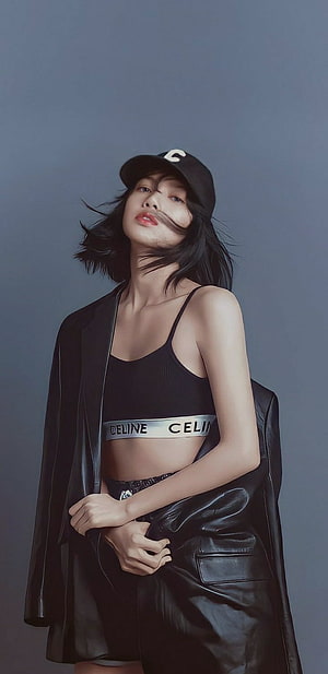 Lisa from BLACKPINK in a black Celine crop top and leather jacket with a baseball cap HD phone wallpaper