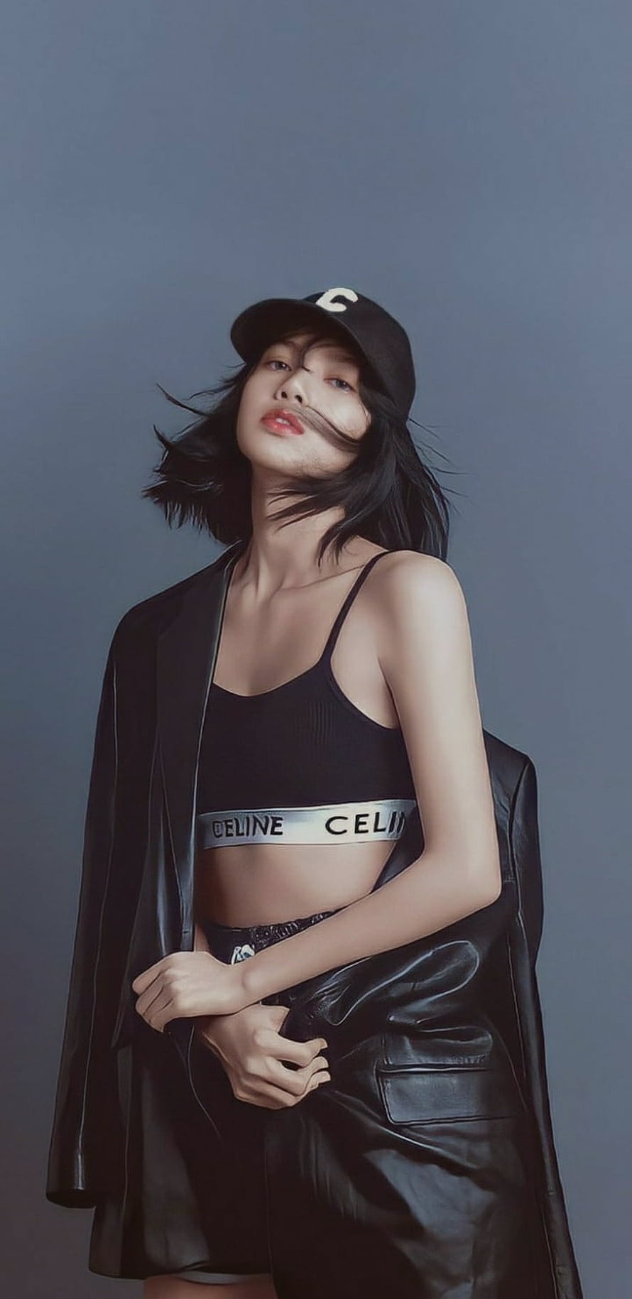 Lisa from BLACKPINK in a black Celine crop top and leather jacket with a baseball cap HD phone wallpaper