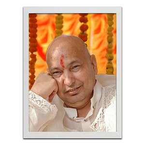 Jai Guruji Portrait in White Attire with Red Tilak Against Orange Marigold Garland Background HD phone wallpaper