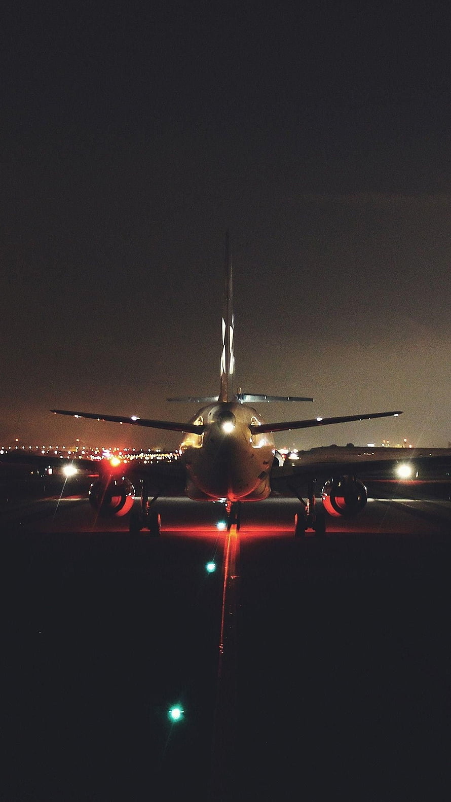 Commercial Jetliner Taxiing on Runway at Night with Red and Green Navigation Lights HD phone wallpaper