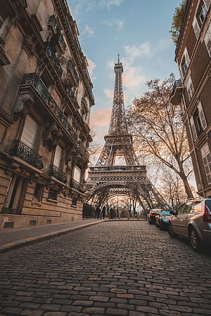 Cobblestone Street Leading to the Eiffel Tower in Paris France at Golden Hour HD phone wallpaper