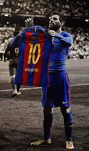 Lionel Messi holding up his Barcelona number 10 jersey on the football pitch HD phone wallpaper