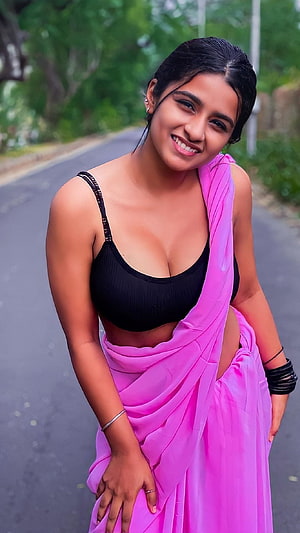 Suhana Khan in a vibrant pink sari and black top on a tree-lined road HD phone wallpaper