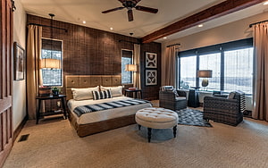 Rustic Master Bedroom With Exposed Beams, Tufted Headboard, and Woven Accent Chairs HD wallpaper