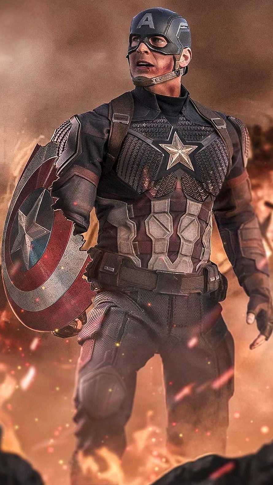 Captain America in Battle Worn Armor Holding a Cracked Shield Amidst Fire and Debris HD phone wallpaper