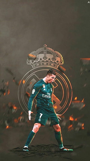 Cristiano Ronaldo in Real Madrid Green Kit with Team Crest and Dramatic Fire Effects HD phone wallpaper
