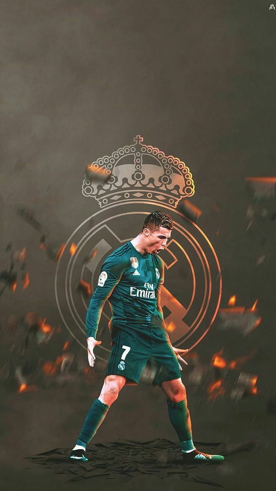 Cristiano Ronaldo in Real Madrid Green Kit with Team Crest and Dramatic Fire Effects HD phone wallpaper