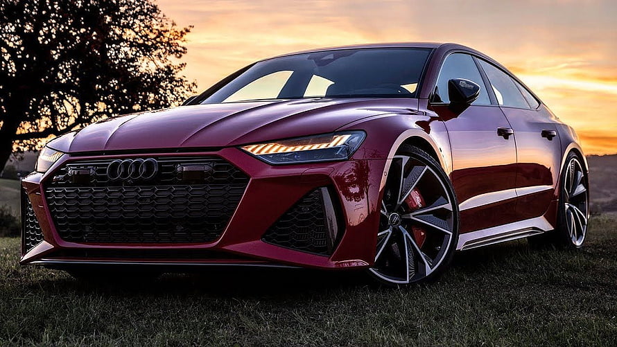 Audi RS7 Sportback in Deep Red Parked on Grass at Sunset HD wallpaper