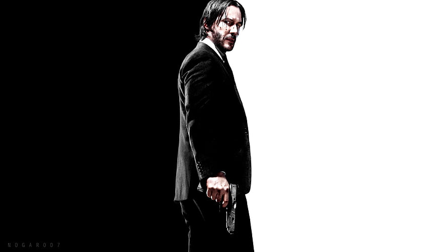 John Wick in a black suit holding a pistol against a high-contrast black and white background HD wallpaper