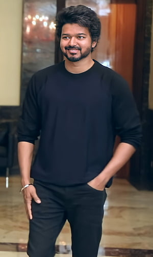 Thalapathy Vijay in a casual black sweater and trousers with a warm smile HD phone wallpaper