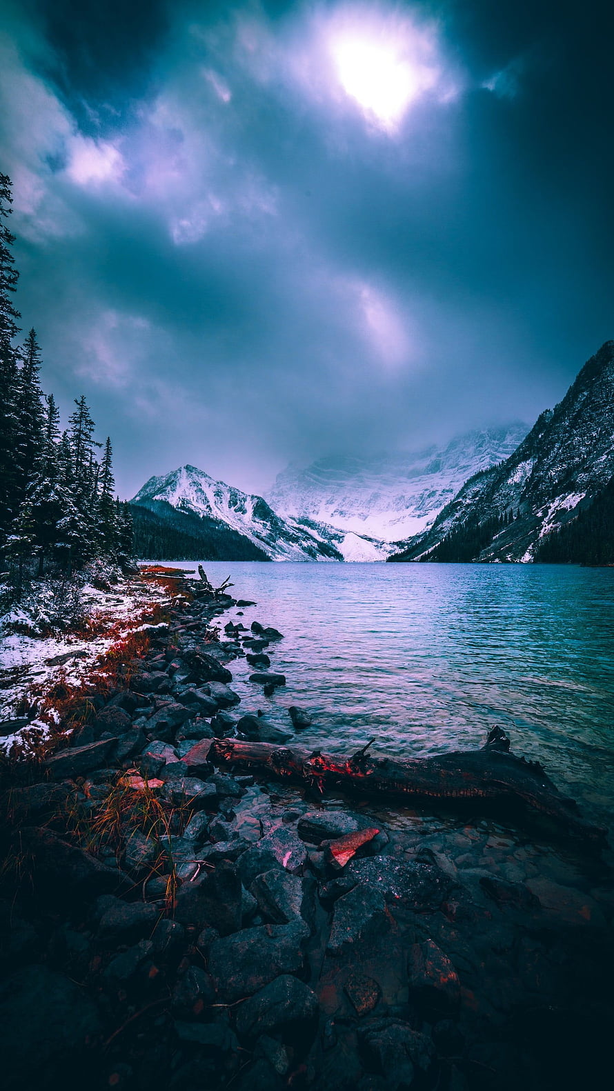 Misty Mountain Lake with Snow-Capped Peaks and Rocky Shoreline HD phone wallpaper