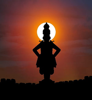 Silhouette of Vithoba Temple Statue Against Vibrant Sunset Sky HD phone wallpaper